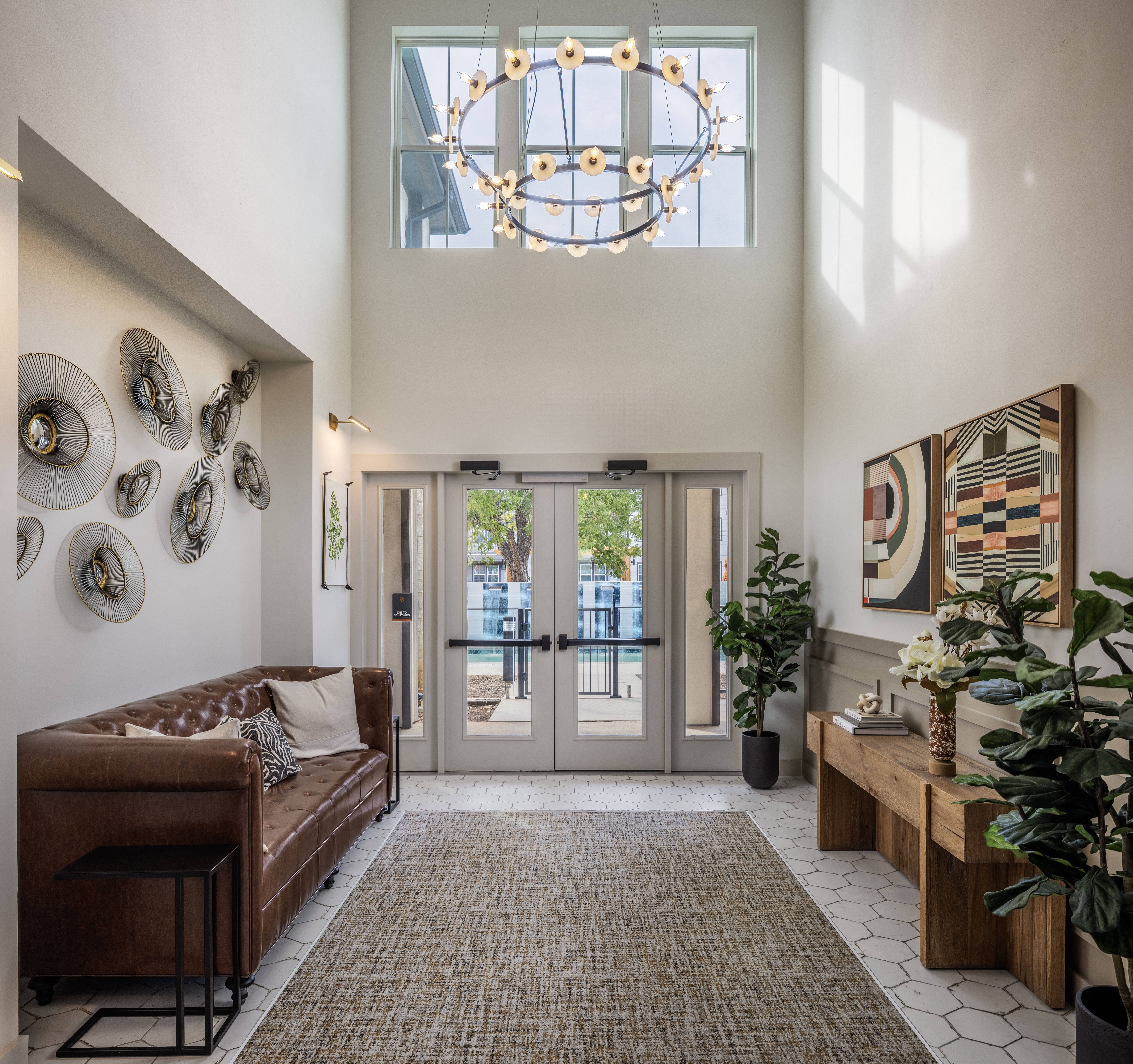 an entryway with seating and a chandelier